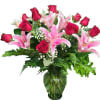 Pink roses and lilies in a glass vase