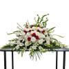 Large white and red floral casket spray with calla lilies and roses