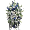 Tall blue and white floral standing spray with a silver ribbon bow