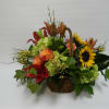 Basket arrangement with sunflowers, lilies, and roses