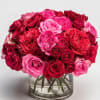 Bouquet of red and pink roses in a clear glass vase