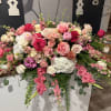 Large pink and white floral arrangement with roses and hydrangeas