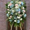 Large standing spray of blue, white, and pink hydrangeas