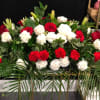 Red and white roses with carnations in a large floral arrangement