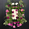 A casket sprayed symbolized peaceful time in this world. Its filled with