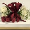 An all white corsage for prom. Its very simple and provides an