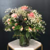 Pink roses and white alstroemeria in a glass vase