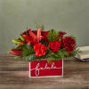 Deck their halls with this lively bouquet studded with surprising red lilies