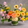 A harmonious blend of peach, blush, cream, and golden blooms creates a