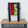Boxed arrangement of red roses and green orchids