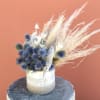 Featuring blue globe thistle, Polly is a burst of neutral preserved elements