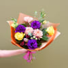 A beautiful and timeless hand-tied bouquet featuring fresh seasonal flowers wrapped in