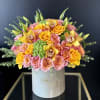 Pink and yellow rose bouquet in a white hat box with orchids