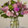 Pink and purple mixed bouquet in a clear glass vase