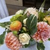Pastel bouquet with pink dahlias, ranunculus, and white blooms in a vase