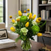 Bright yellow tulips take center stage in this spring-ready flower arrangement, perfect