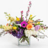 Colorful mixed flower arrangement in a clear glass vase