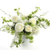 White and green floral arrangement in a white vase