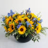 Yellow sunflowers and blue flowers in a black bowl vase