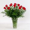 Red roses arranged in a clear glass vase