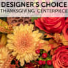 Autumn floral centerpiece with red roses and a large yellow chrysanthemum