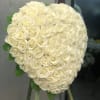 Large heart-shaped bouquet of white roses on a stand