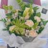 Choice of 12 white roses, green lilies, and Bells of Ireland with