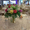 Round centerpiece of multicolored roses on a banquet table