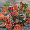 Peach and coral paired with orange-and-cream blossoms create a warm, rustic garden-style
