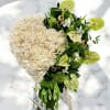 Heart-shaped bouquet of white roses with green anthuriums and orchids