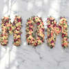 Floral letters spelling "MOM" made of pastel roses