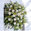 Large white rose arrangement with green and yellow accents