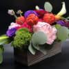 Colorful mixed flower arrangement in a rectangular box with calla lilies