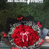 Bouquet of red roses with baby's breath and black wrapping