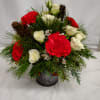 Red and white roses with carnations in a small vase