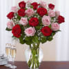 Bouquet of red and pink roses in a clear glass vase