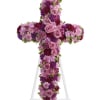 Purple and pink floral cross on a white stand