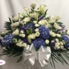 White and blue floral arrangement with a large silver bow