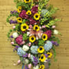 Large standing floral spray with sunflowers, hydrangeas, and ribbon