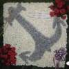 White floral funeral tribute with a gray dove design and red rose clusters