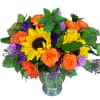 Bouquet of sunflowers, orange roses, and purple filler in a glass vase