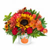 Fall bouquet in a white pumpkin vase with sunflowers and mixed blooms