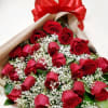 Bouquet of red roses with baby's breath and a large red bow