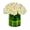 White roses arranged in a clear glass vase