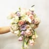 Handheld bouquet of pastel roses and calla lilies