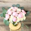 Bouquet of pink and white peonies with round eucalyptus leaves