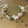 Floral crown with white and pink small flowers on a ribbon tie