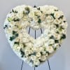 Heart-shaped white floral wreath with roses on a stand