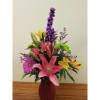 Mixed bouquet with pink lilies, yellow alstroemeria, and purple flowers in a vase