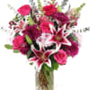 Pink roses and lilies in a clear glass vase